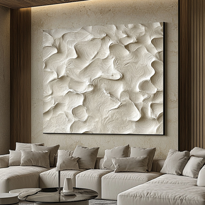 Cream textured artwork displayed above a contemporary sofa
